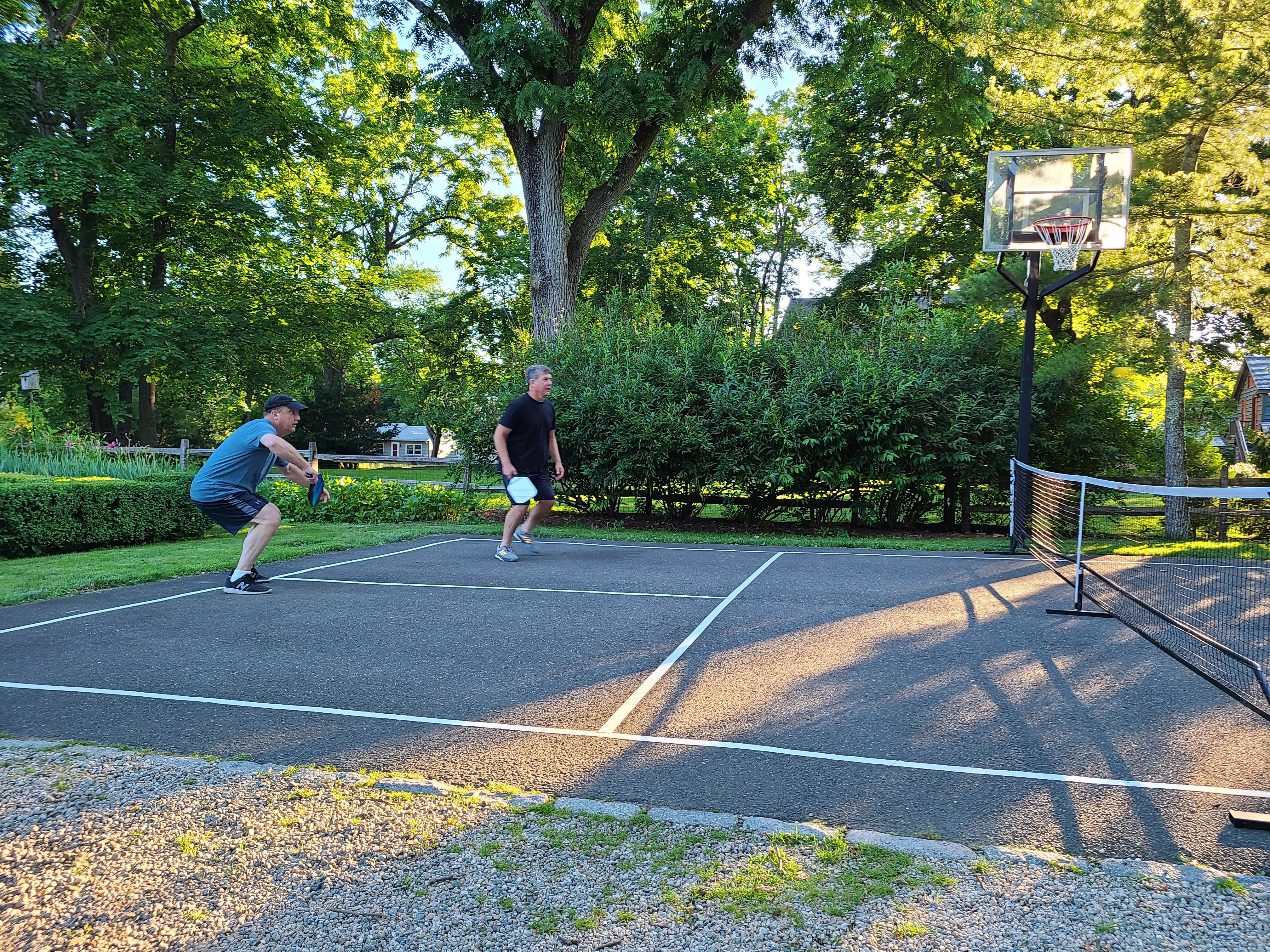 Two players competing on a backyard pickleball court